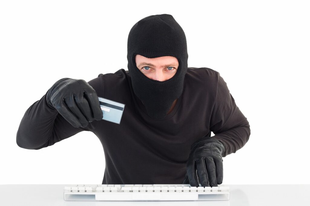 Hacker using card to steal identity on white background