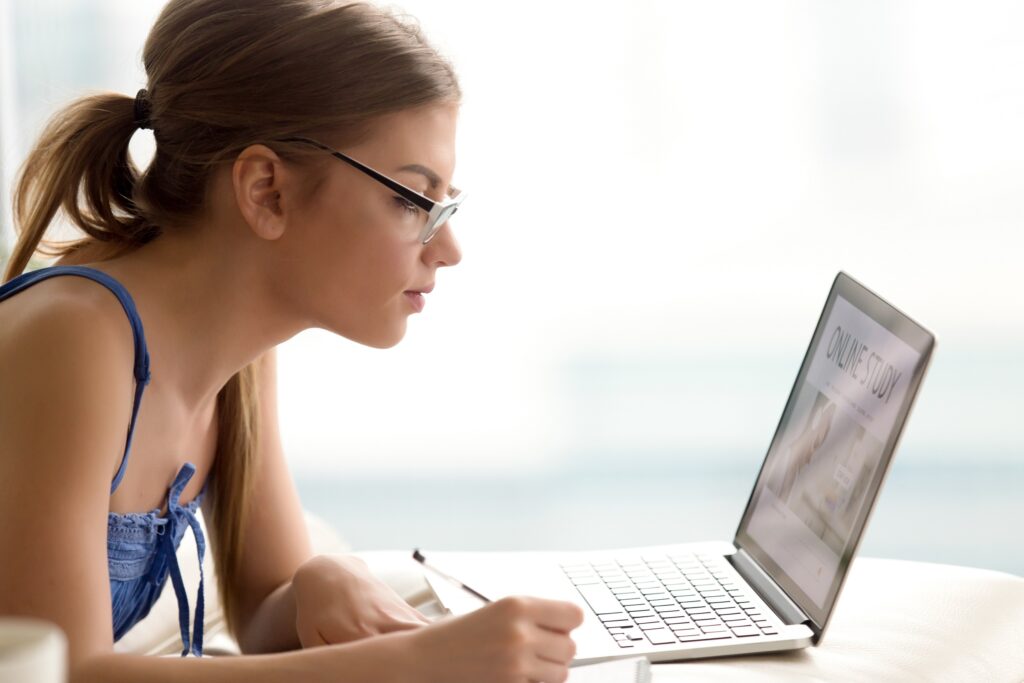 Female student studying online with laptop